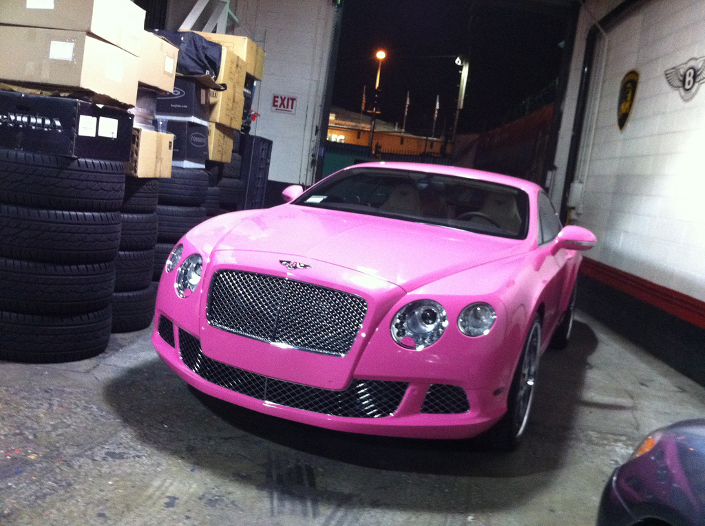 Nicki Minaj, aka Pink Barbie Doll, just picked up a new Bentley Continental GT. This car is a perfect fit for her, matches her more than it does Paris Hilton. The only problem I have with this car is the cheap cast wheels. You go out and paint an entire Bentley in pink but you get cheap on the rims? The wheels probbably cost $200 each. She should have gotten a set of 3-piece wheels that were color matched pink and chrome two tone. Instead she chose machined wheels with a high polished lip right out of China which does not match the car at all.  Might want to use some of that plastic surgery budget for the wheels on your car Nicki.