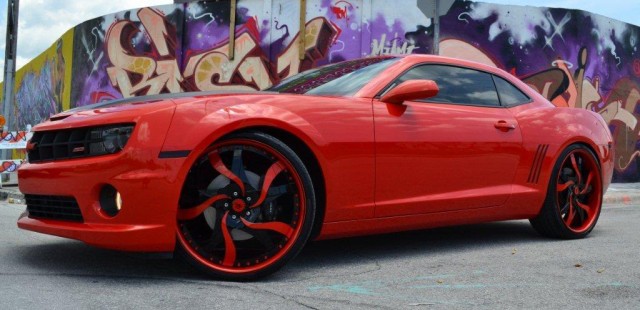 Asdrubal Cabrera of the Cleveland Indians has his Camaro customized at MC Customs in Miami, FL. This car is definately not for everybody. The wheels are as loud and crazy as it gets, with 24″ Forgiato Mistos. They hooked him up with a great sound system with his name and jersey number incorporated into it.  These wheels are too crazy for my taste and I think it makes the car look silly. These wheels would be perfect for a donk or an Escalade but I dont think they were meant for a muscle car. Also, the wheels are loud enough without the wild color scheme on them, it might have worked with an all black center and orange lip. [via celebritycarz.com]